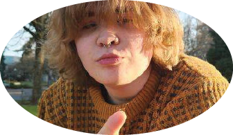 Maegan in orange sweater with bug on finger